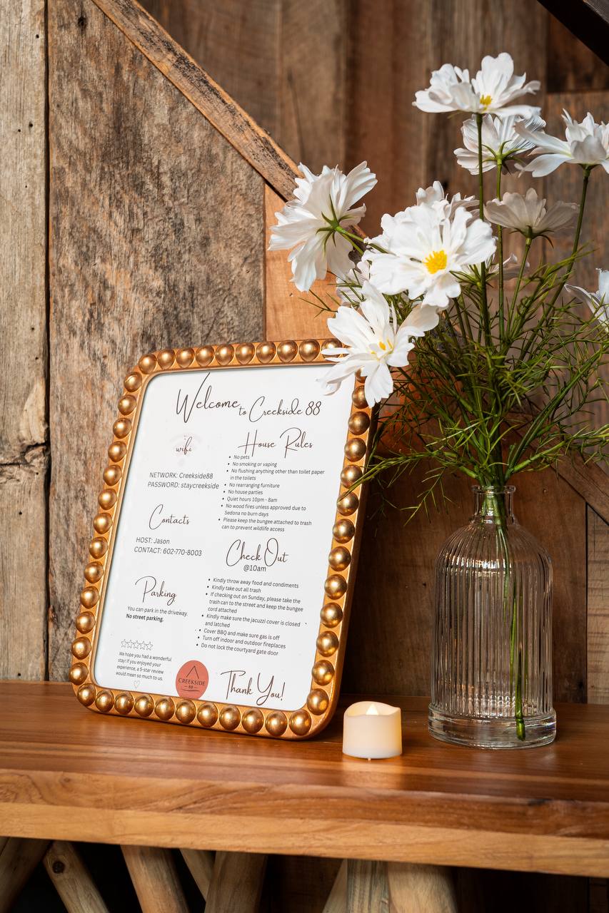Welcome to Creekside 88 sign with house rules and fresh flowers
